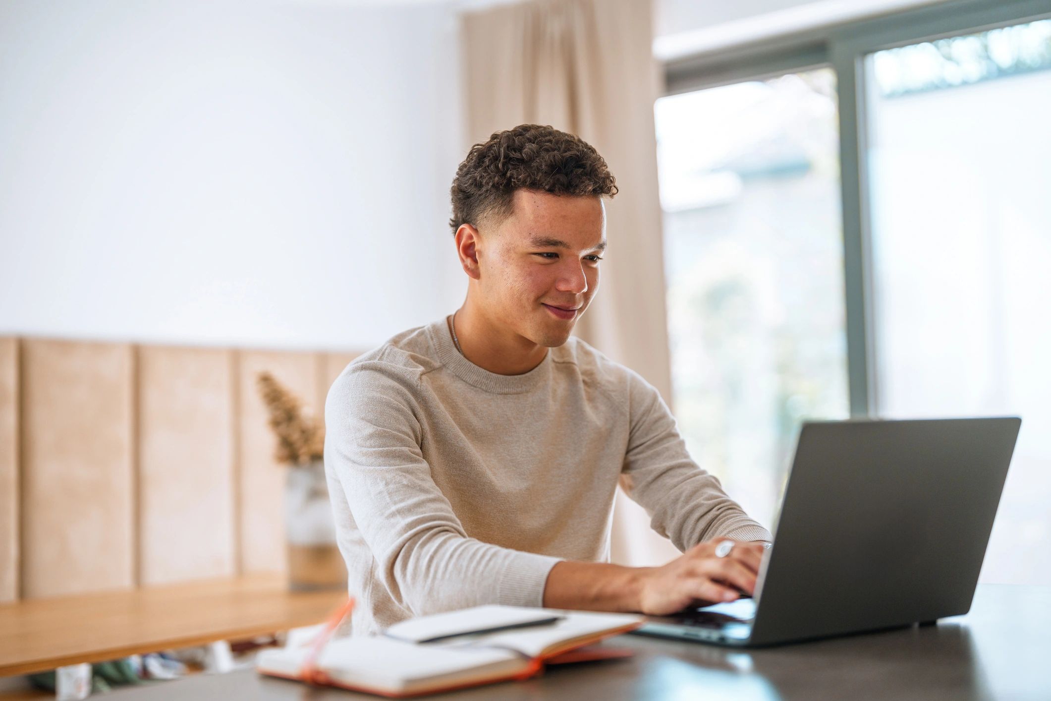 Student studying with laptop and notes
