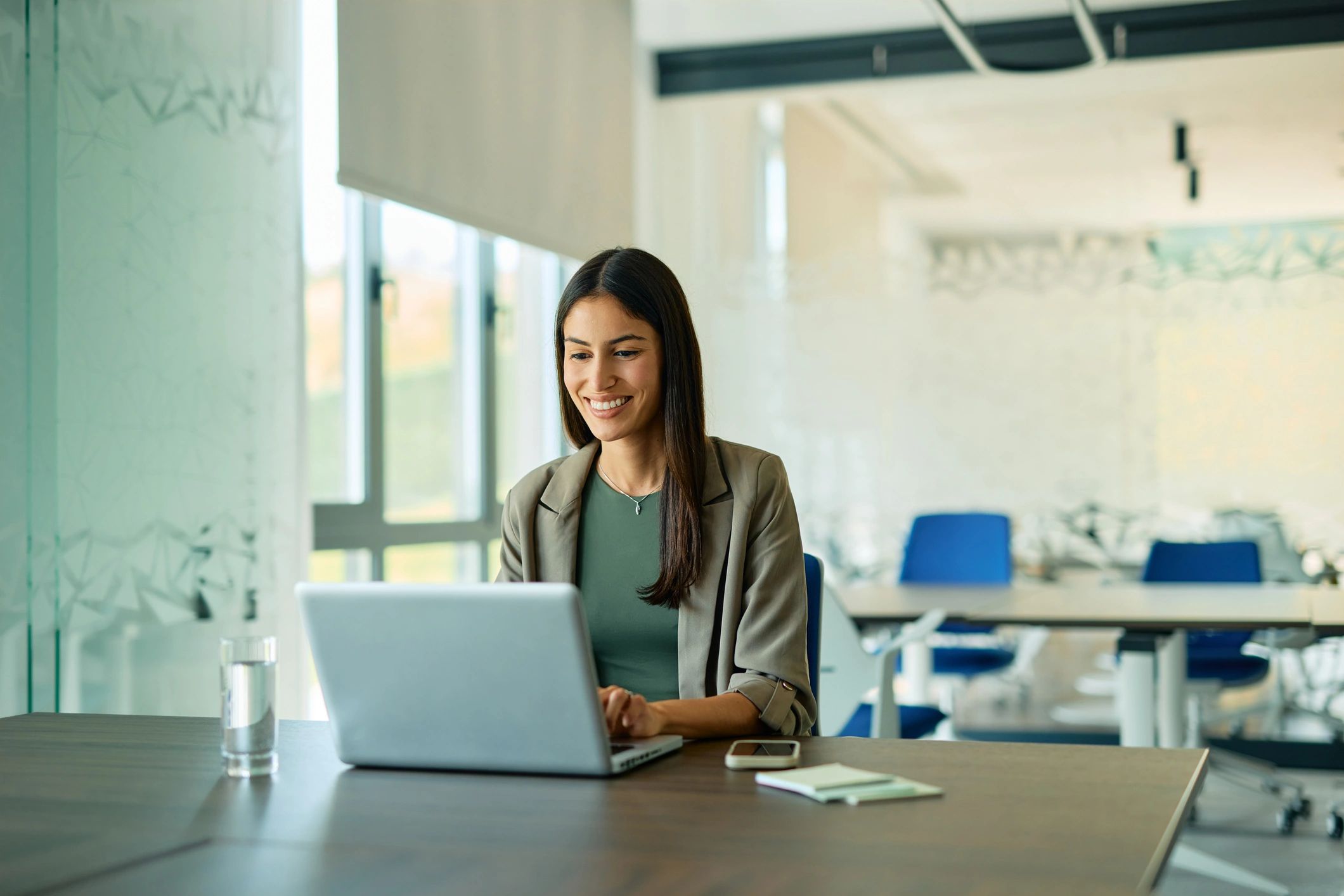 Professional working on laptop in modern office