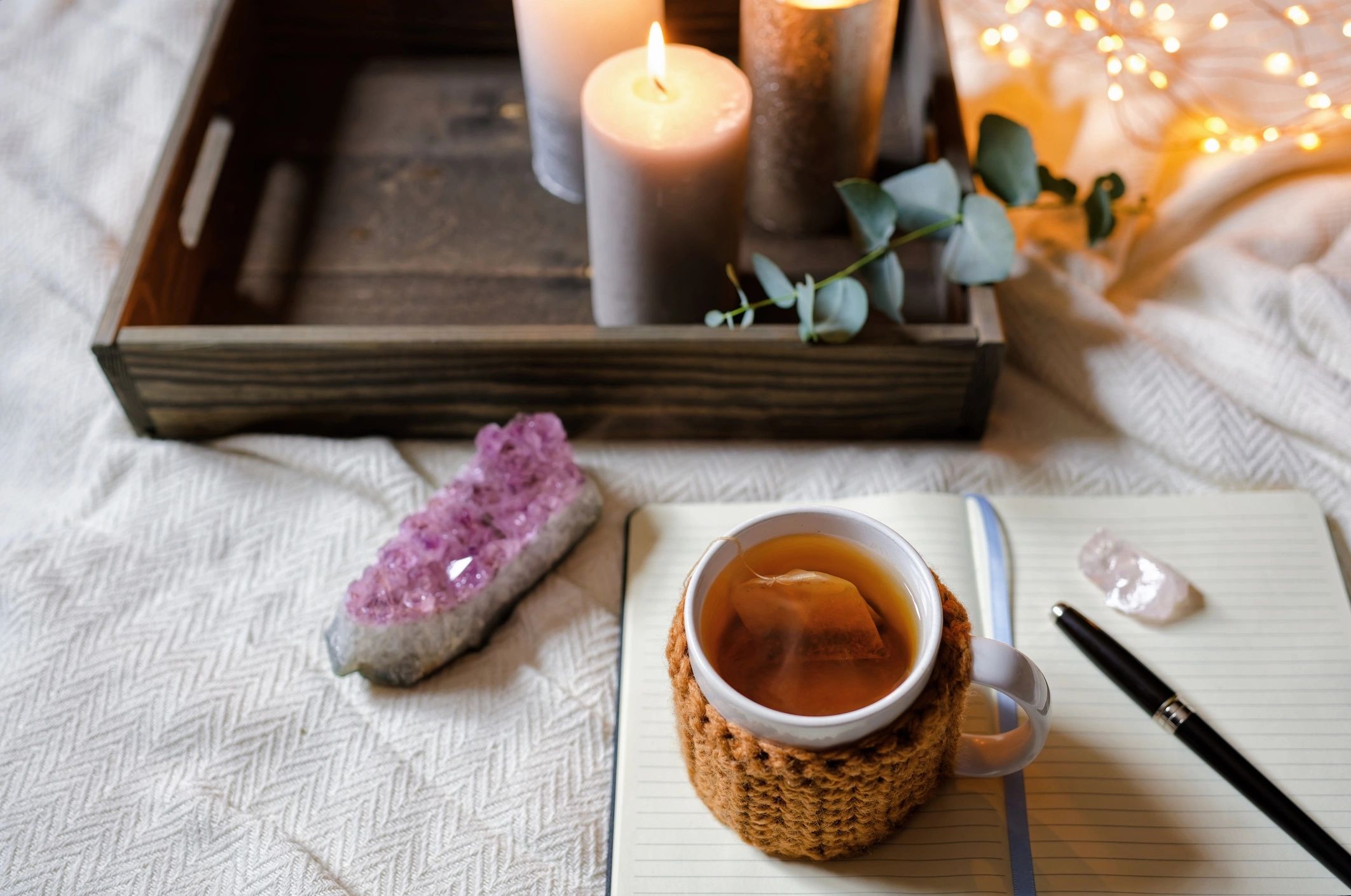Open journal with tea and candlelight